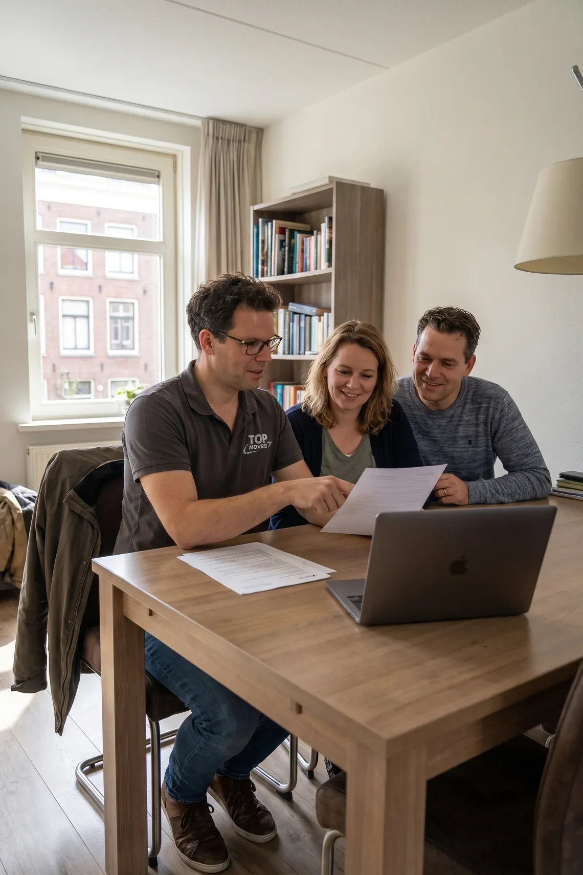 Verhuisadviseur neemt aan de eettafel de internationale verhuizing door met een stel